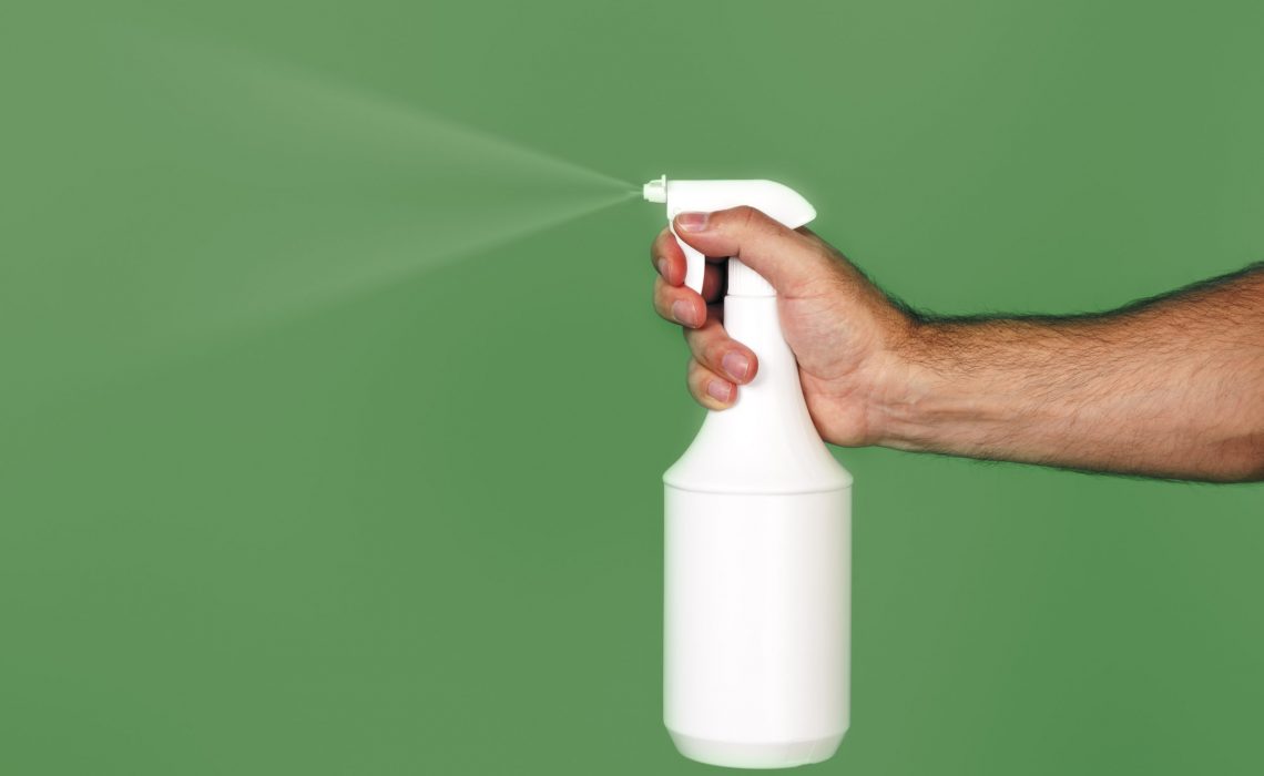 An image of a spray over green background